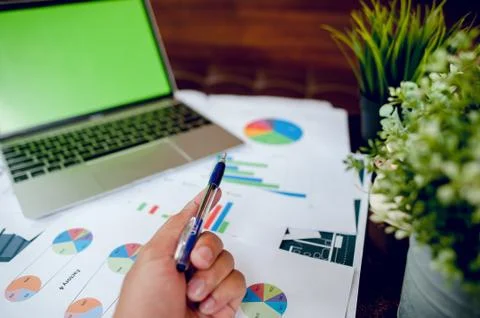 The desk and graph are placed on the business desk. Business concept With cop Stock Photos