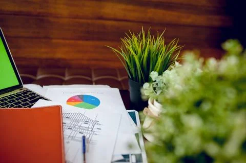 The desk and graph are placed on the business desk. Business concept With cop Stock Photos