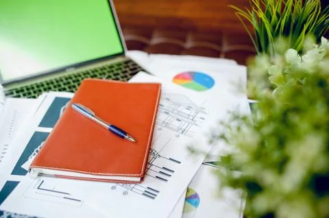 The desk and graph are placed on the business desk. Business concept With cop Stock Photos