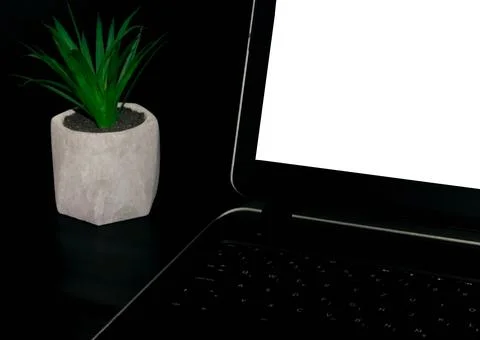 Desk and laptop. Black background. Stock Photos