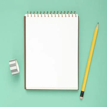 Desk arrangement with empty notepad blue background Beautiful photo Foto stock