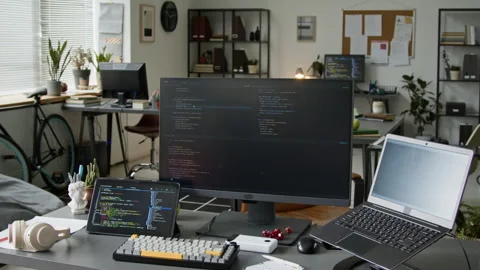 Desk of Backend Software Developer with Code on Laptop, Computer and Tablet Stockbeeldmateriaal 335937765