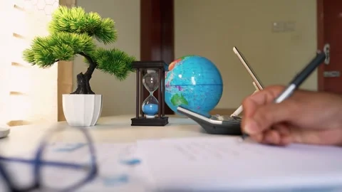 Desk with Bonsai Tree and Writing Hand Stock Footage 320725933