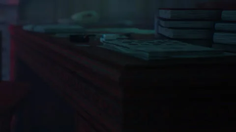 Desk with books and papers in a dimly lit room at night Stock Footage 344966574