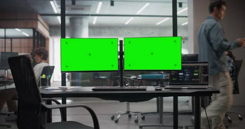Desk with Computer Screens with Green Screen in Office Stock Footage 321012362