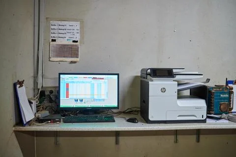 A desk with a computer on a table Stock Photos