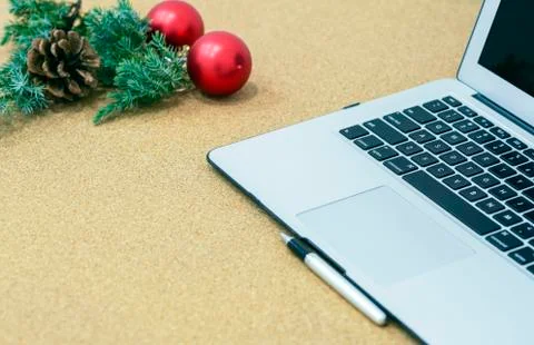 Desk during the holidays with Christmas decorations and a pen and notebook Stock Photos