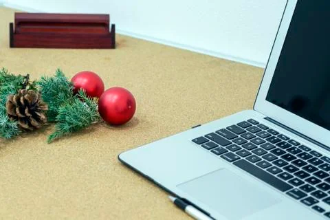 Desk during the holidays with Christmas decorations and a pen and notebook Stock Photos