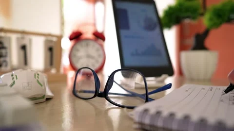 Desk Essentials for Productivity and Focus, Close-up of a desk with glasses.. Stock Footage 317737184