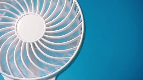 Desk fan on cool blue background Stock Footage 314258047