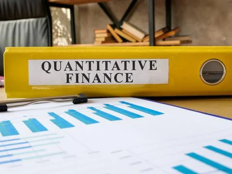 Desk with folder quantitative finance on it. Stock Photos
