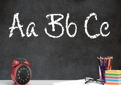 Desk foreground with blackboard graphics of ABC spelling Stock Photos