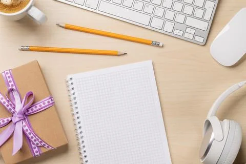 Desk with a gift and notepad Stock Photos