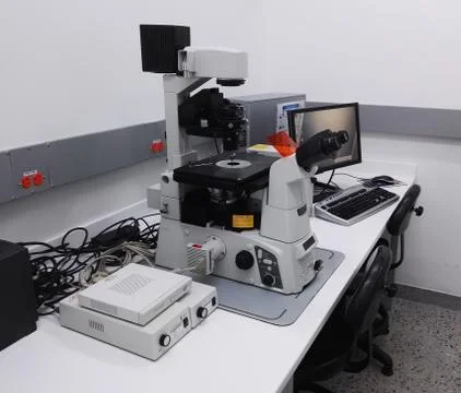 Desk with a high-tech microscopy station, fluorescence microscope, in laboratory Stock Photos