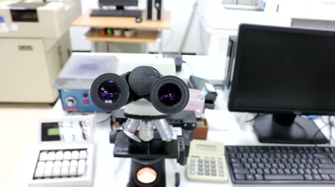 Desk in the lab with a gradual zooming on the microscope Stock Footage 60793537