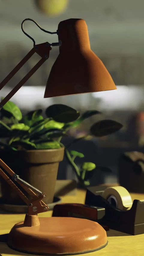 Desk lamp illuminates workspace in a classroom with plant and tape dispenser Stock Footage 315871578