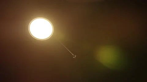 Desk light coming on and glaring at the lens in a dark room Stock Footage 209644741