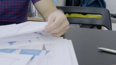 At desk man analyzes data, which are depicted on different graphs. Stock Footage 85767708