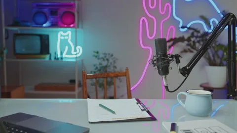 Desk with Mic, Laptop and Papers in Video Studio with Neon Decor Stock Footage 269106509