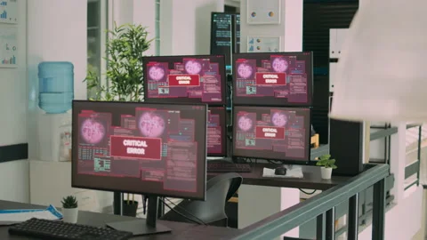 Desk with multiple monitors displaying error message on screen Stock Footage 231449330