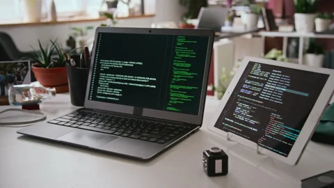 Desk of Programmer at IT Company Office, Laptop with Running Code and Tablet Stock Footage 285713133