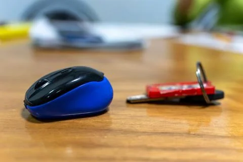 Desk setup with computer mouse and keys on wooden table surface Stock Photos