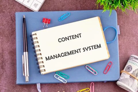 Desk setup features a notepad labeled content management system alongside sta Stockfoto's