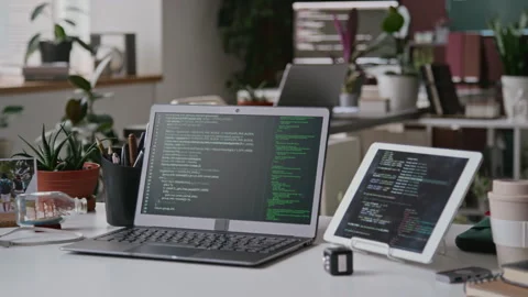 Desk of Software Developer at IT Startup with Laptop and Tablet Stock Footage 285712149