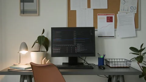 Desk of Software Engineer with Computer Code on Black Screen in Startup Office Stock-Footage 335937947