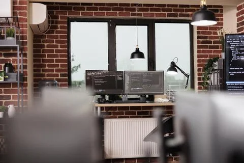 Desk table with multiple monitors running terminal window Stock Photos