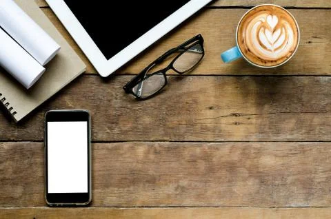 Desk work with smartphone, tablet, coffee cup  and notebook.Top view with cop Stock Photos
