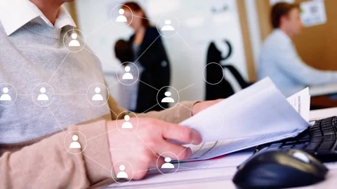 Desk worker sifting papers for business, causing network nodes overlaying hands, Stock Footage 335282017