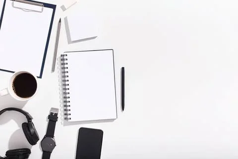 Desk workspace with notebook pen coffee and tech items Stock Photos