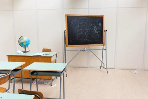 Desks and blackboard in classroom at school Stock Photos