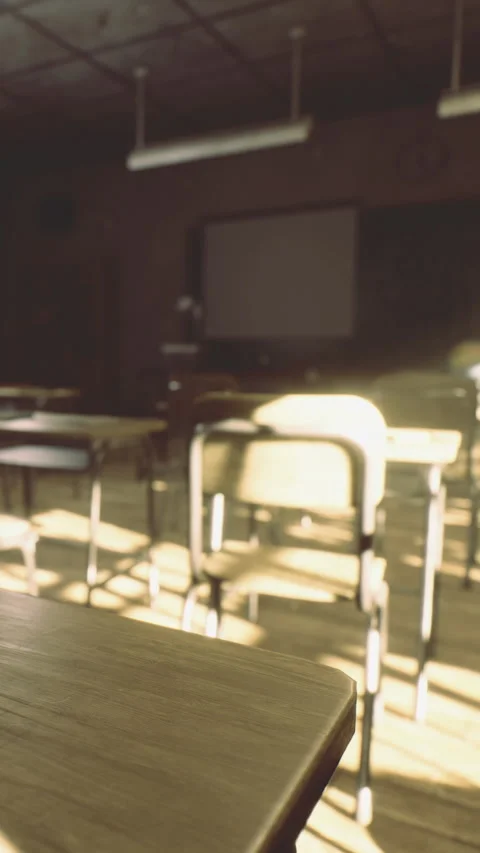 Desks and chairs in an empty classroom with sunlight in the afternoon Stock Footage 336178221