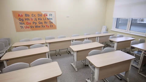 Desks with chairs rows and ABC placard in English class Vídeos de archivo 335193846