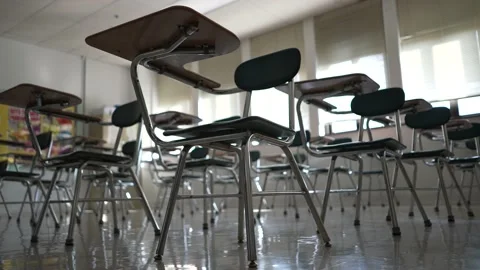Desks in empty dark high, middle, or elementary school classroom with light 스톡 동영상 167951433