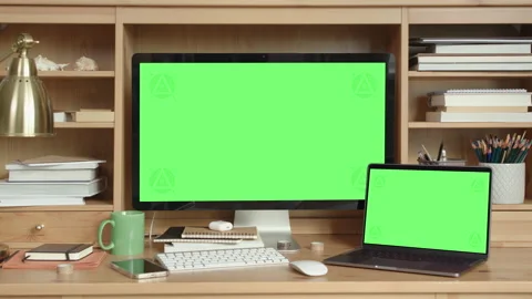 Desktop and Laptop Computers with Green Screen in Home Office Interior Video stock 172132426