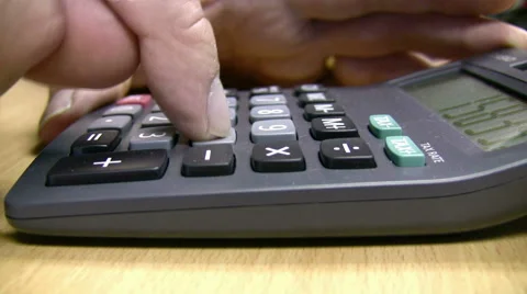 Desktop calculator close up  being used by man to reckon figures cinemagraph Video stock 59940432