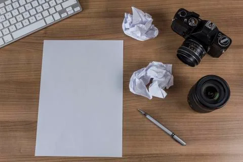 Desktop with camera and blank sheet Stock Photos
