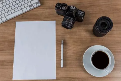 Desktop with camera blank sheet and coffee Stock Photos