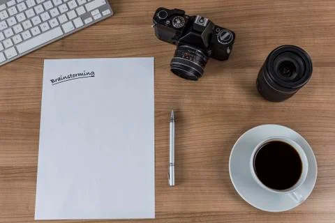 Desktop with camera blank sheet and coffee Stock Photos