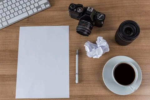 Desktop with camera blank sheet and coffee Stock Photos
