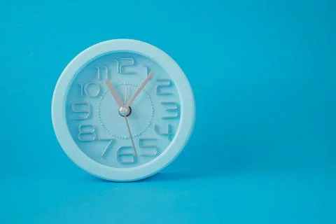 Desktop classic clock alarm clock isolated on blue background Illustration