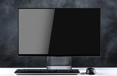 Desktop computer on a dark background. Stock Photos