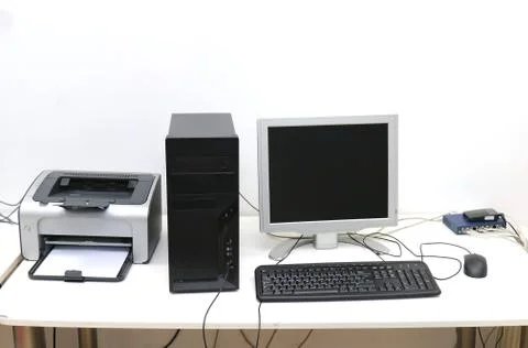 Desktop computer with display keyboard mouse and printer on desk Stock Photos