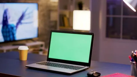 Desktop computer with green screen on home office. Stock Photos