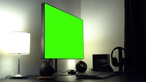 A desktop computer setup with a green screen on an office table - closeup Stock Footage 246317450