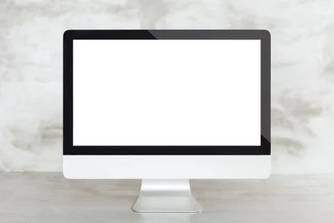 Desktop computer on work desk showing blank screen Foto stock