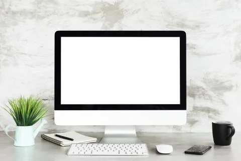 Desktop computer on workspace table showing blank white screen Stock Photos